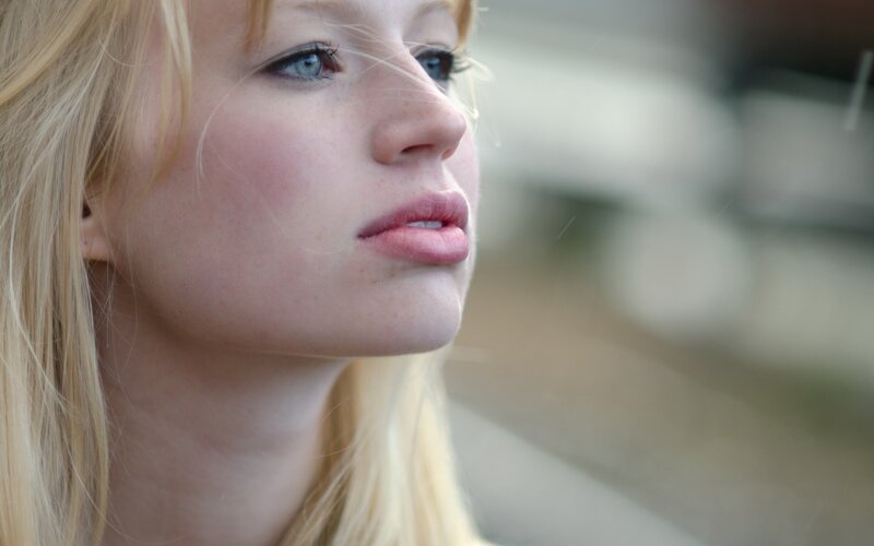 woman with blonde hair looking away