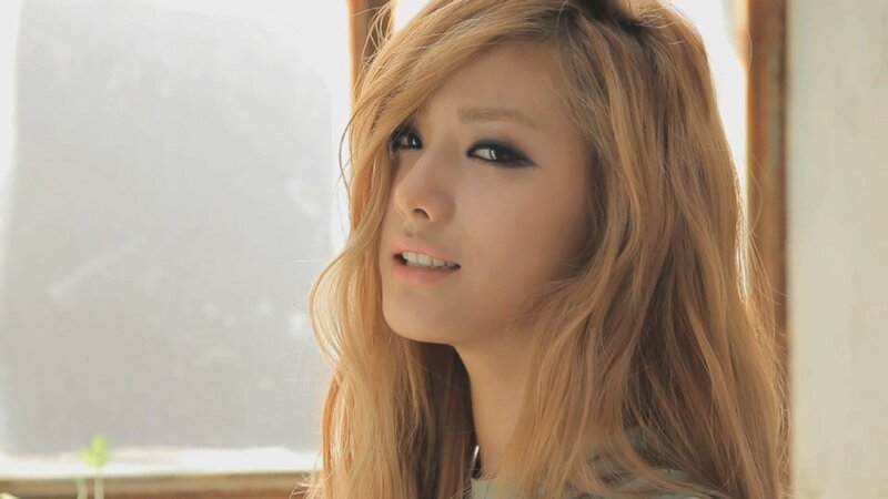 woman with blonde hair looking away