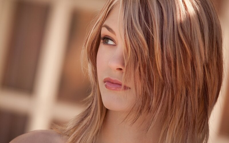 woman with blonde hair looking away