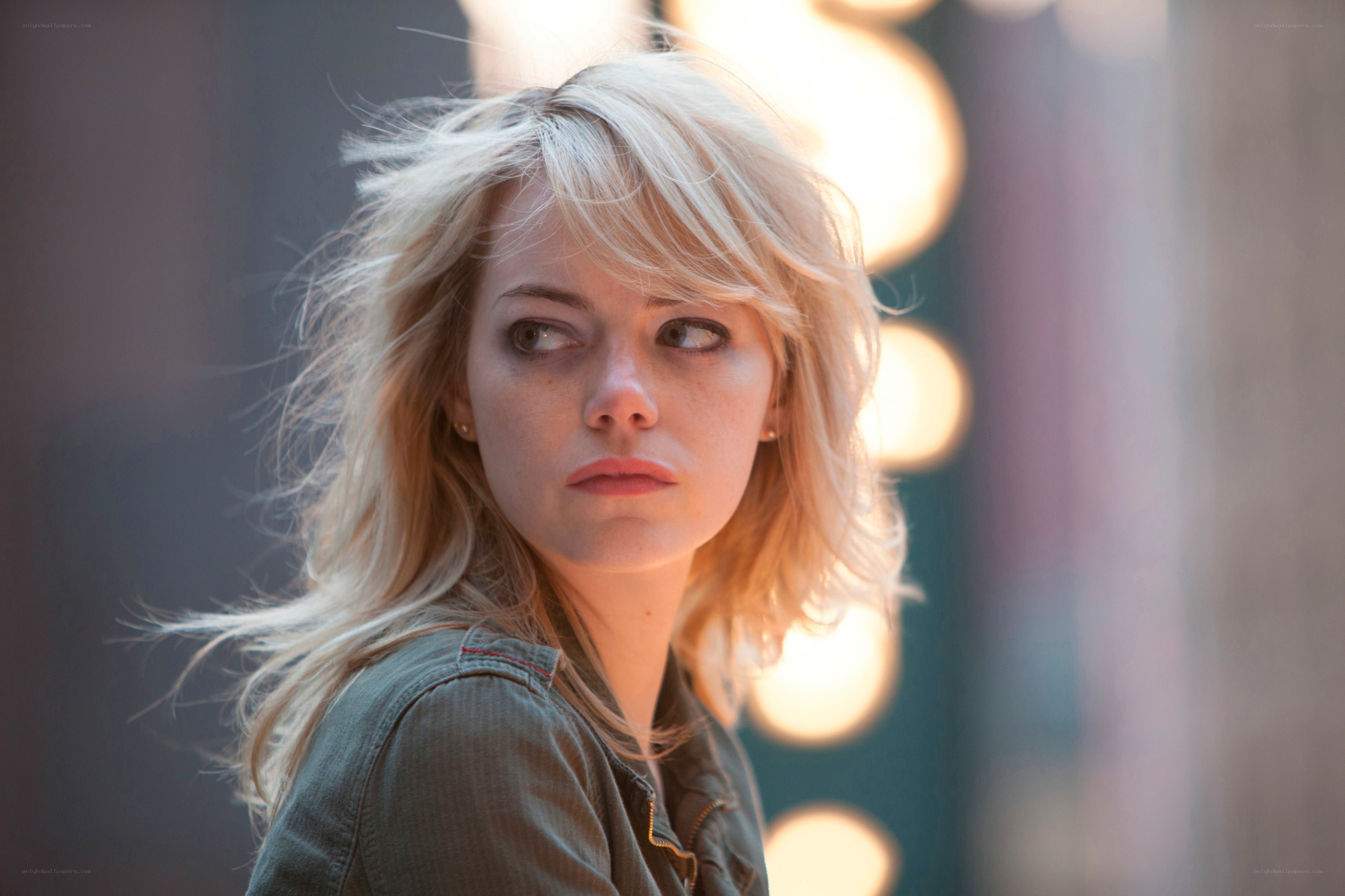 woman with blonde hair looking away