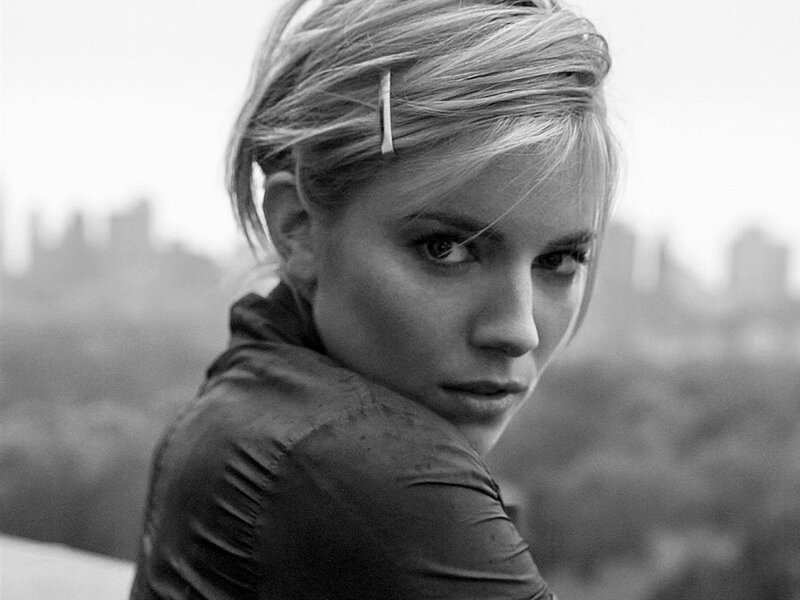 woman with blonde hair looking back