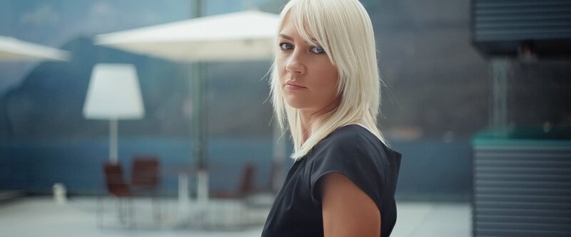 woman with blonde hair looking back