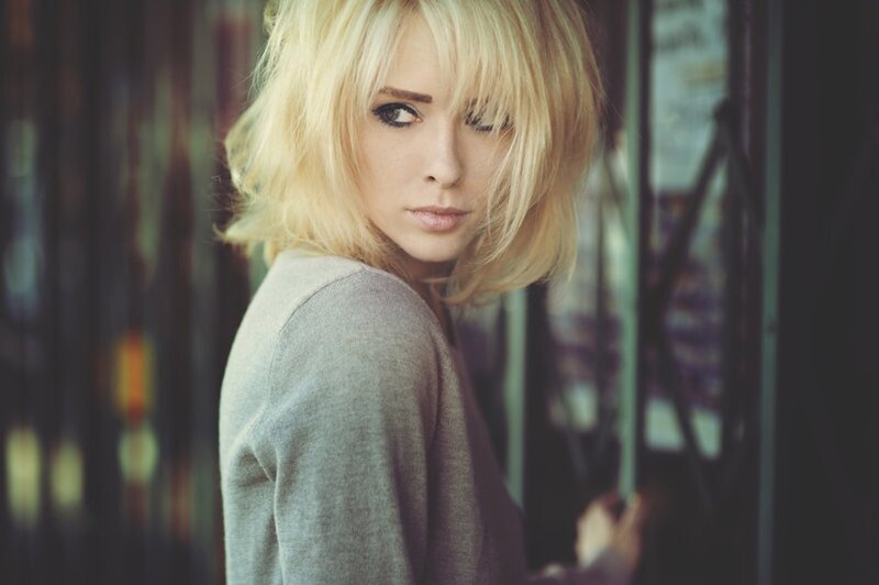 woman with blonde hair looking back