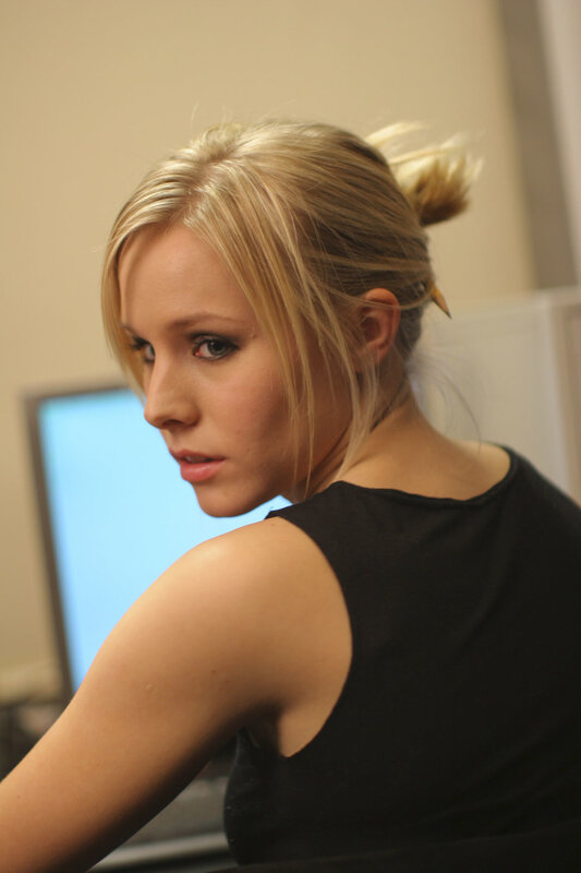 woman with blonde hair looking back