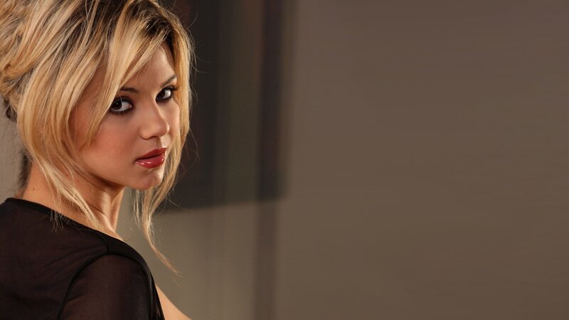 woman with blonde hair looking back