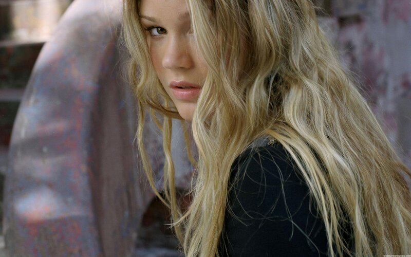 woman with blonde hair looking back