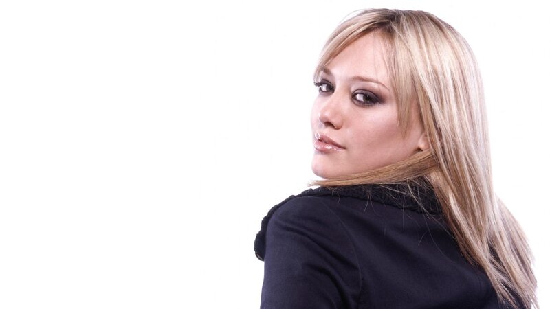 woman with blonde hair looking back