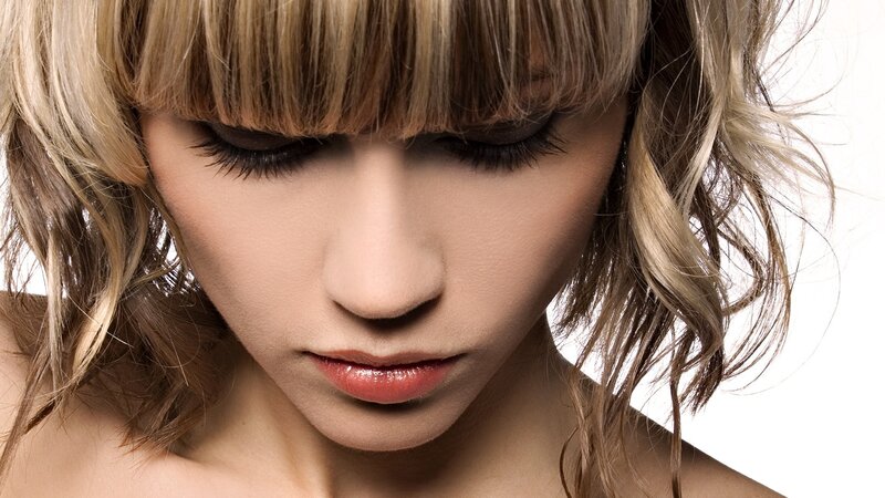 woman with blonde hair looking down