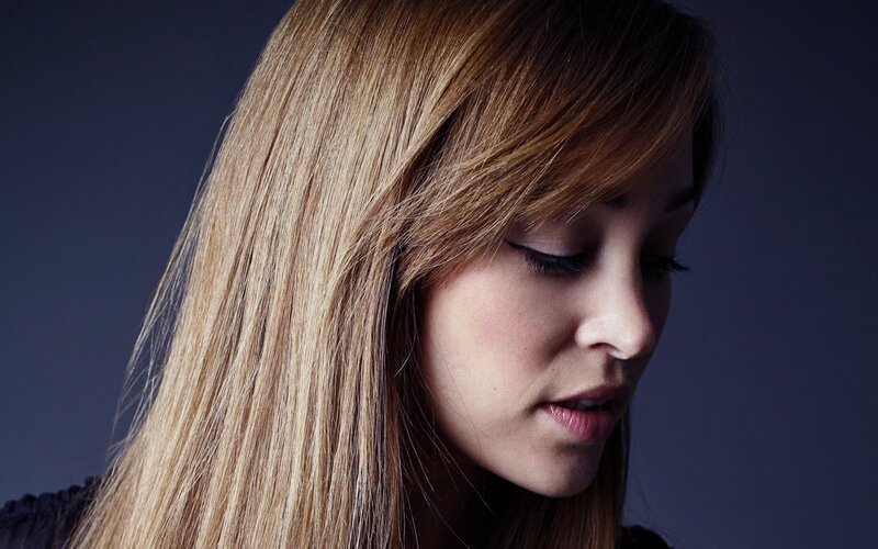 woman with blonde hair looking down