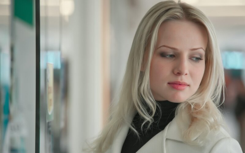 woman with blonde hair looking down