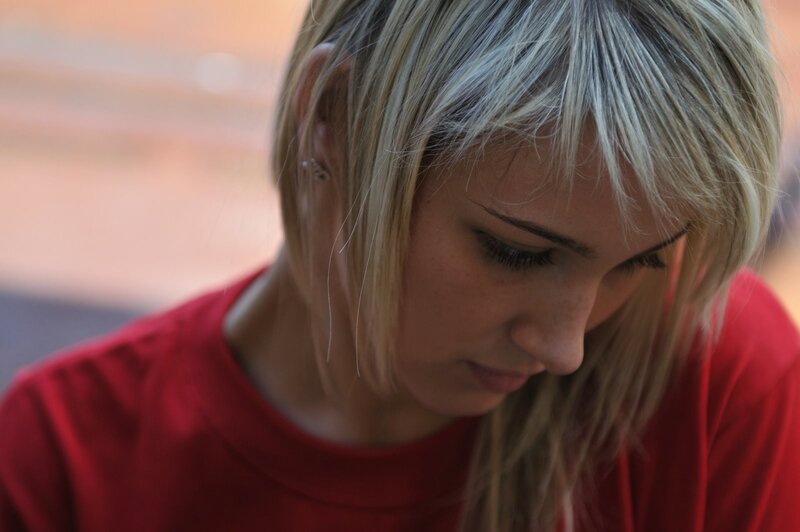woman with blonde hair looking down