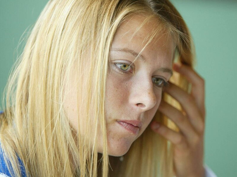 woman with blonde hair looking down