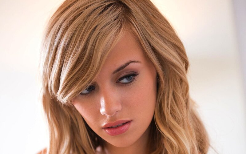 woman with blonde hair looking down