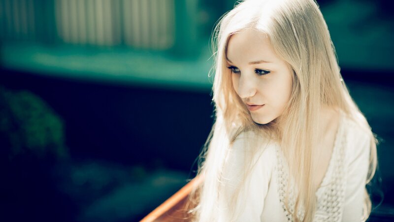 woman with blonde hair looking down