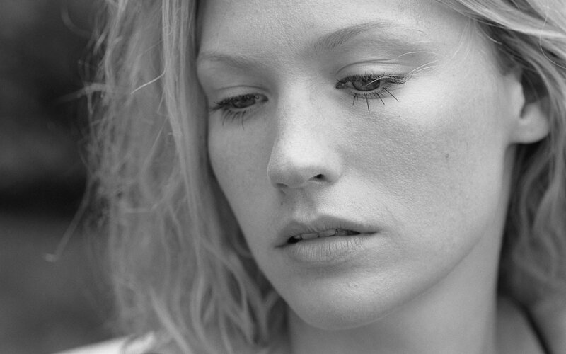woman with blonde hair looking down