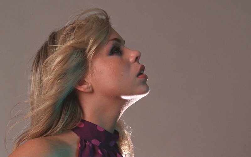 woman with blonde hair looking up