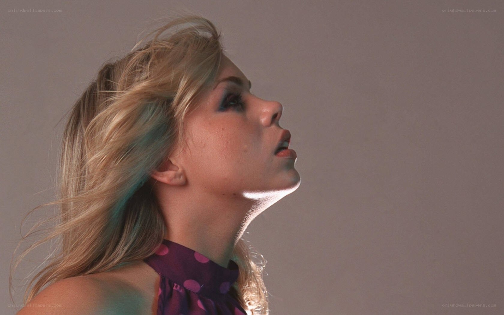 woman with blonde hair looking up