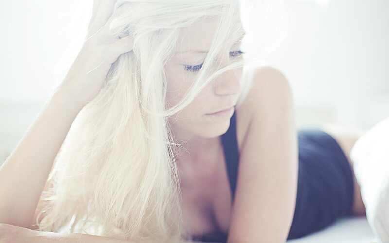 woman with blonde hair lying down