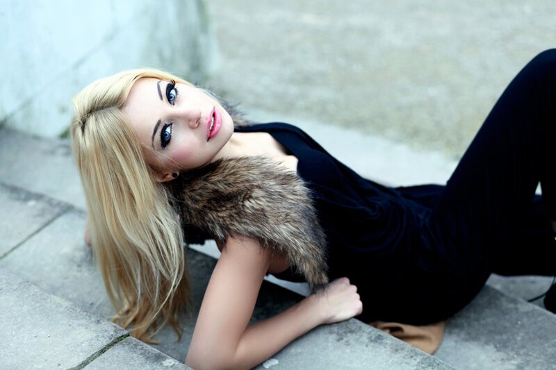 woman with blonde hair lying on steps