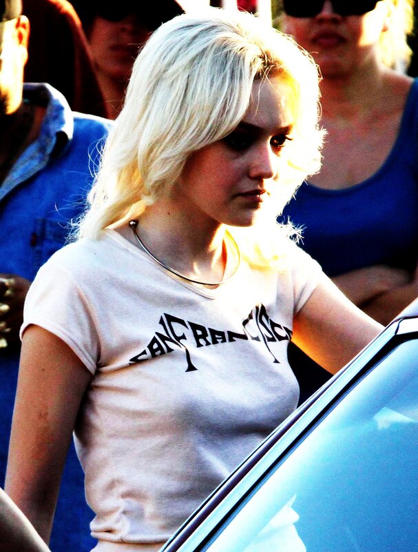 woman with blonde hair near car