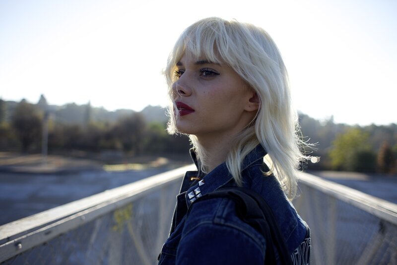 woman with blonde hair on a bridge