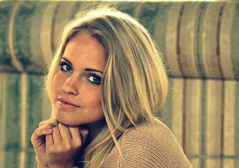 woman with blonde hair resting chin