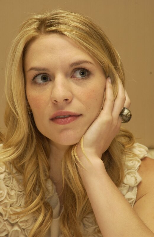 woman with blonde hair resting hand on face