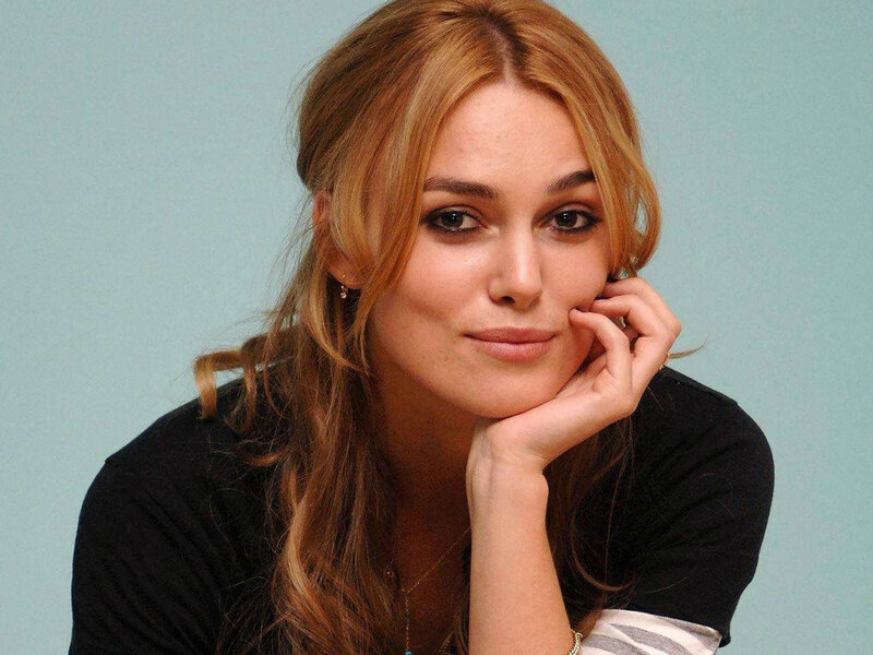 woman with blonde hair resting her chin