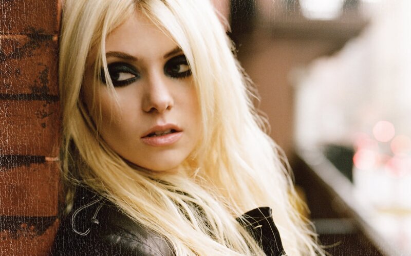 Woman with Blonde Hair — Serious, Photograph, Brick Wall, Black Jacket