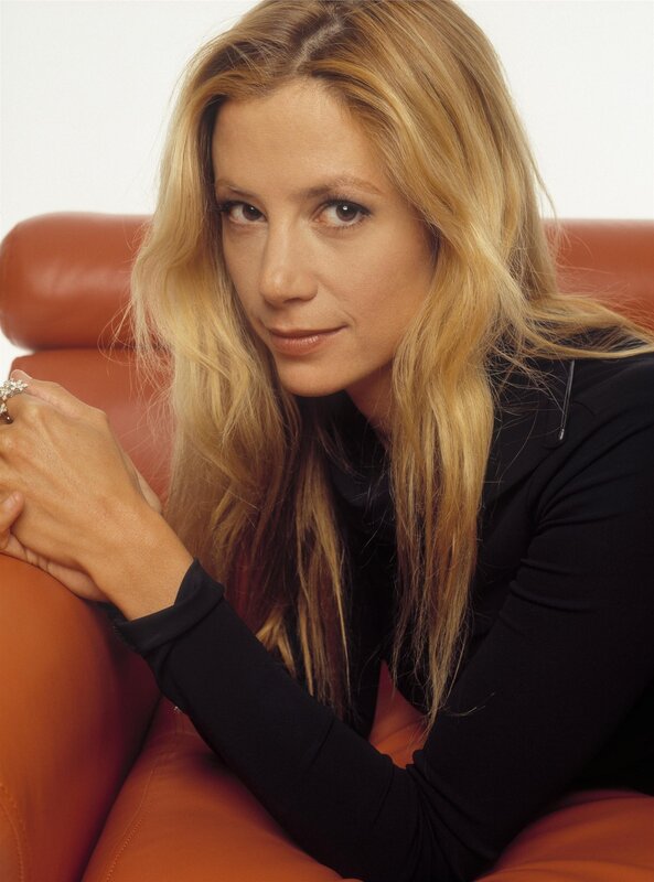 woman with blonde hair sitting on couch
