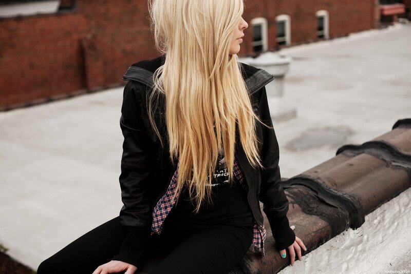 woman with blonde hair sitting on rooftop