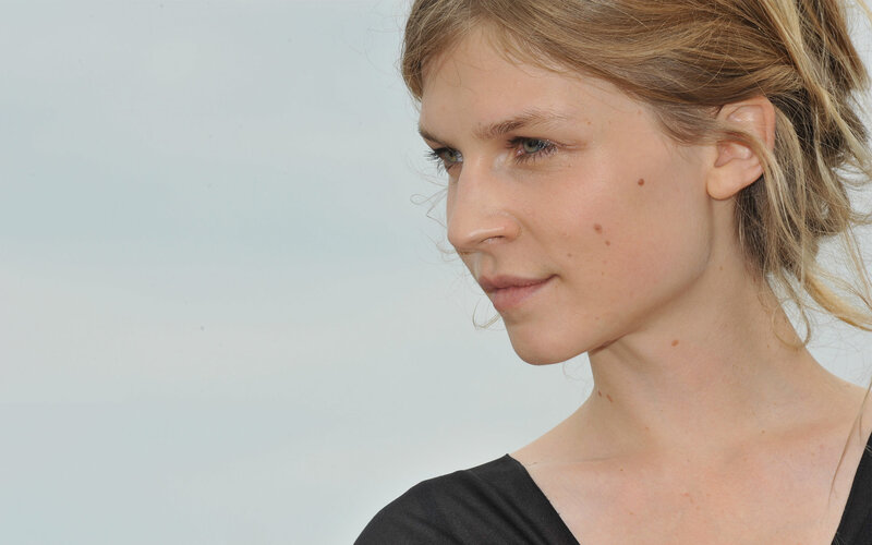 Woman with Blonde Hair — White, Neutral, Photograph, Black Top, Light Background