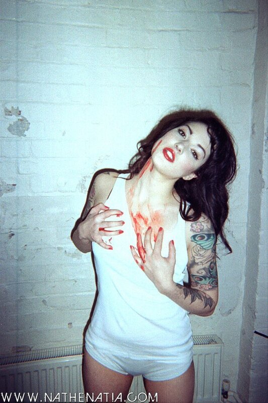 woman with blood and tattoos