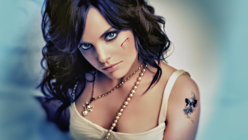 woman with blood tear tattoo