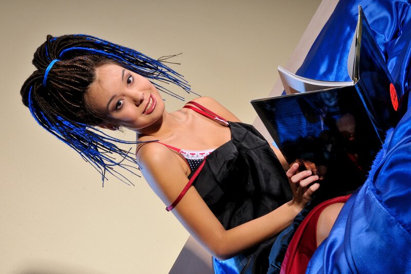 woman with blue braids reading book