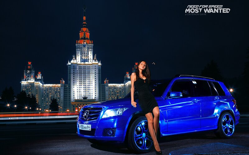 Woman with blue car at night