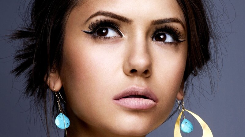 woman with blue earrings