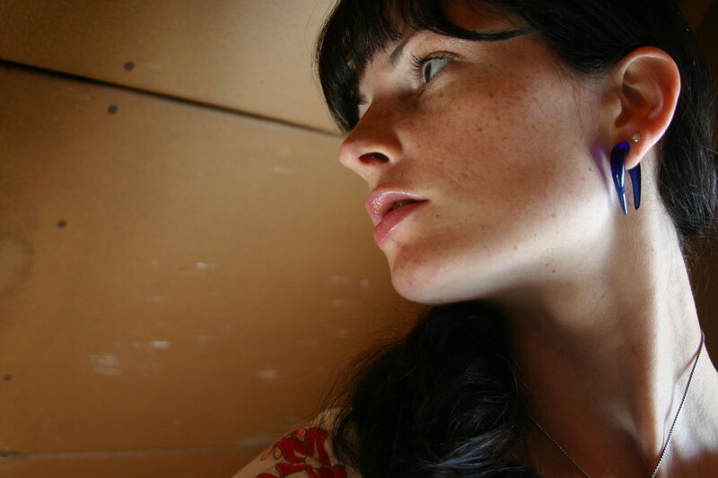 woman with blue earrings