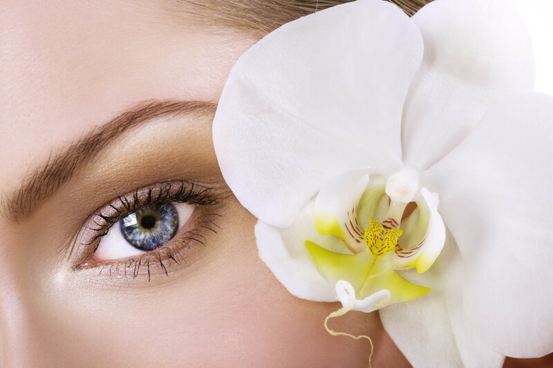 woman with blue eye and white orchid