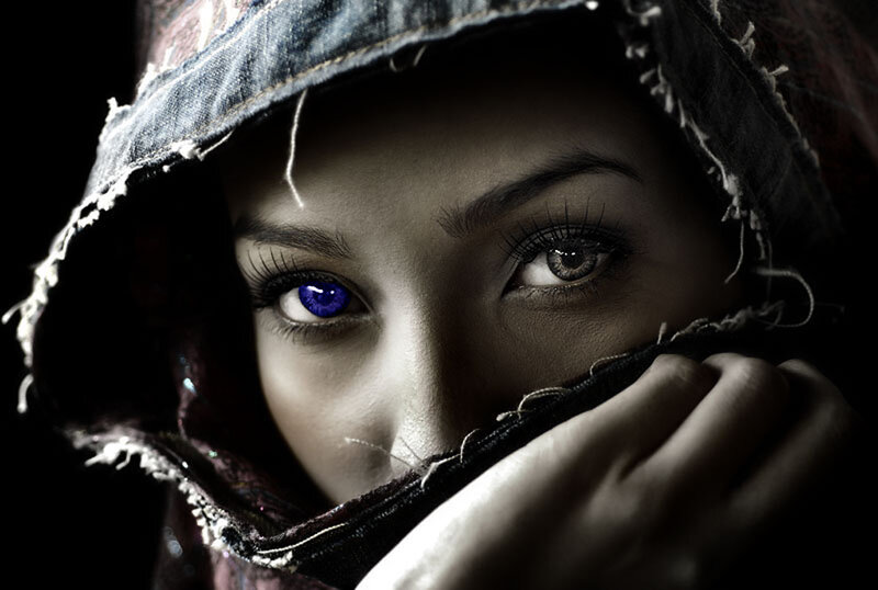 woman with blue eye in hood