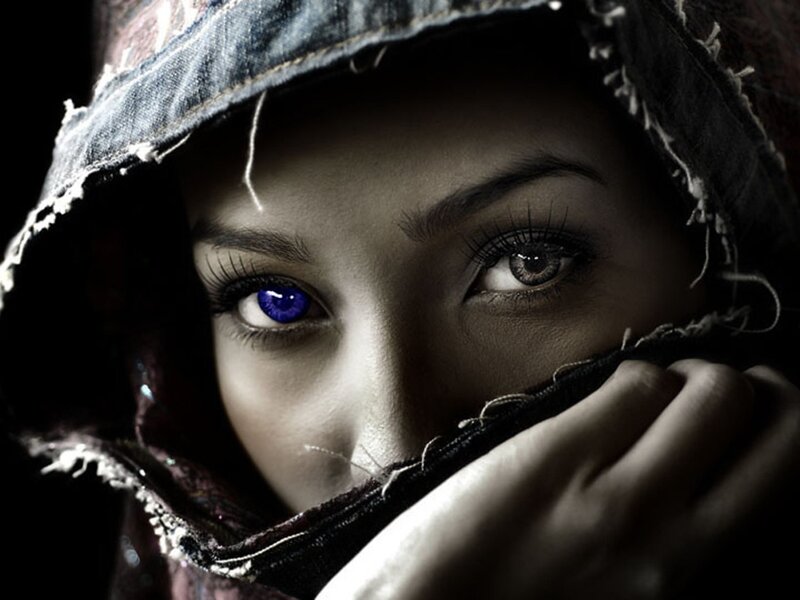 woman with blue eye in hood