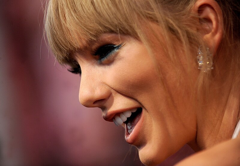 woman with blue eyeliner smiling