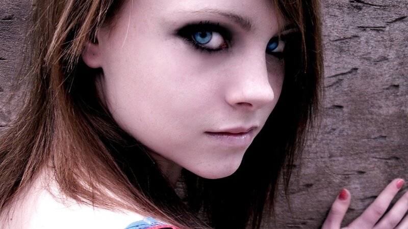 woman with blue eyes against wall