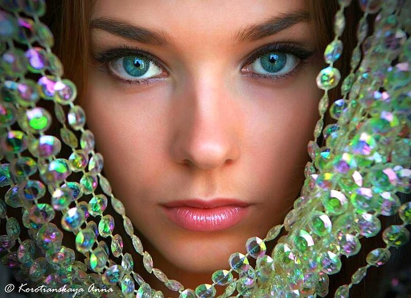 woman with blue eyes and beads