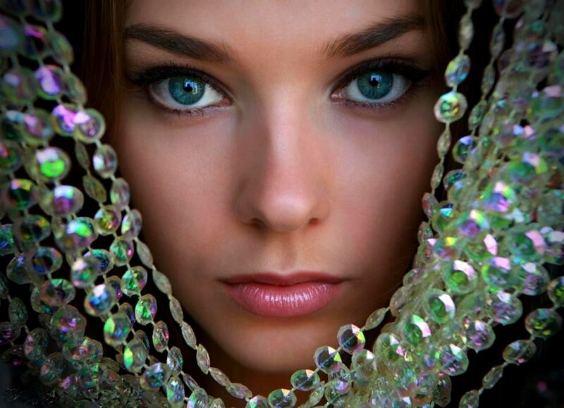 woman with blue eyes and beads