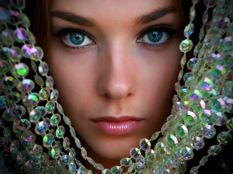 woman with blue eyes and beads