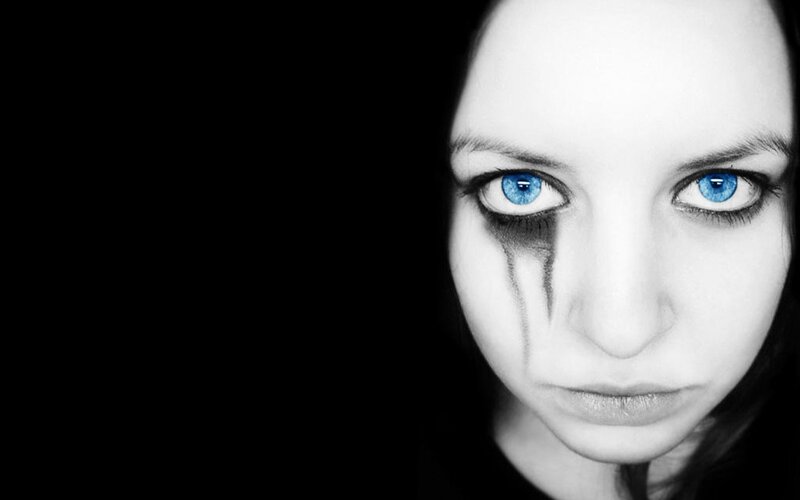 woman with blue eyes and black makeup