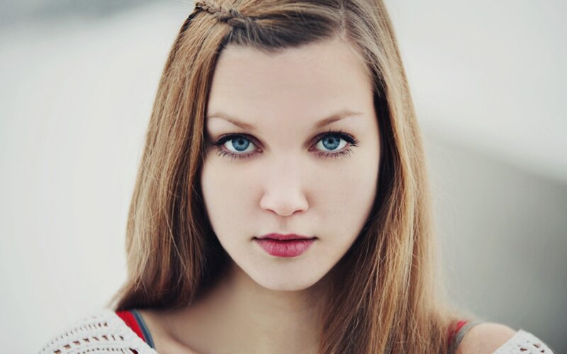 woman with blue eyes and braided hair