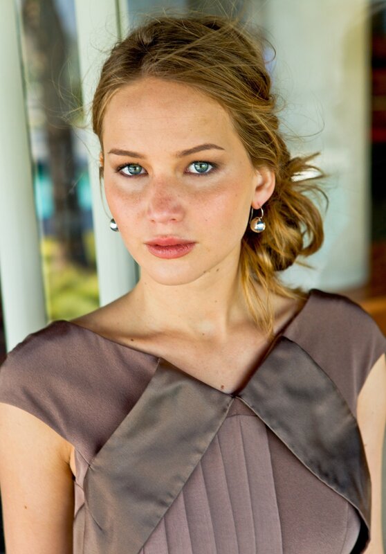 woman with blue eyes and brown dress