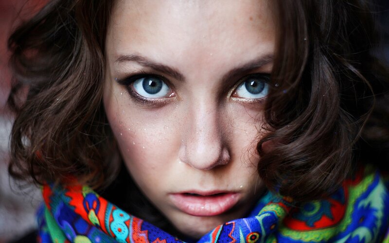 woman with blue eyes and colorful scarf